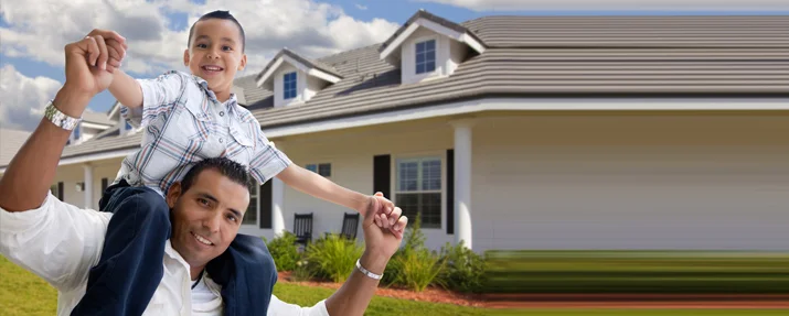 Father and son in front of their home